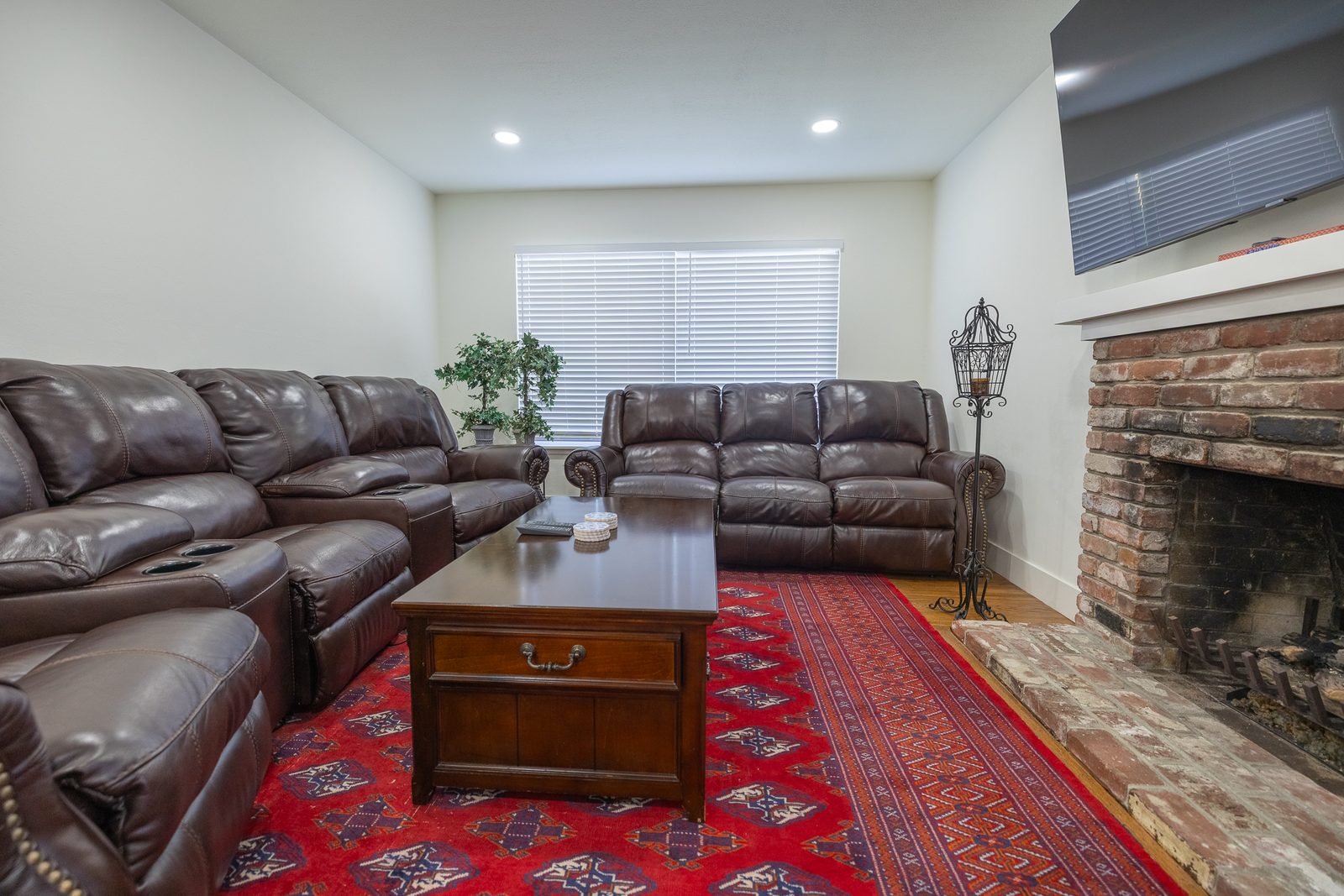 Living room with brick fireplace